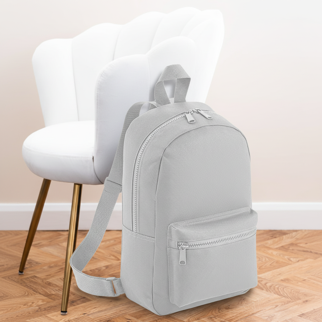 Mini Essential Bagbase Backpack (light grey) with aesthetic background
