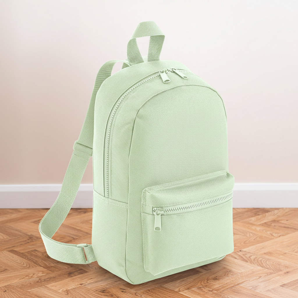 Mini Essential Bagbase Backpack (pistachio) with aesthetic background