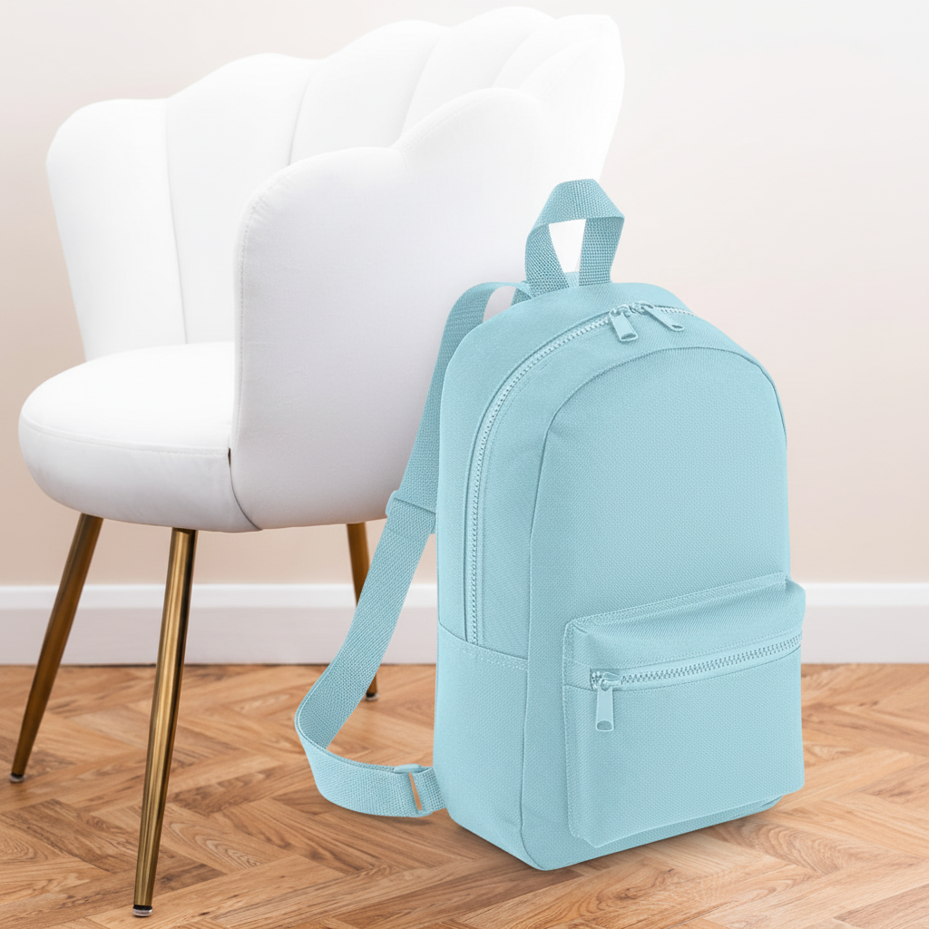 Mini Essential Bagbase Backpack (powder blue) with aesthetic background