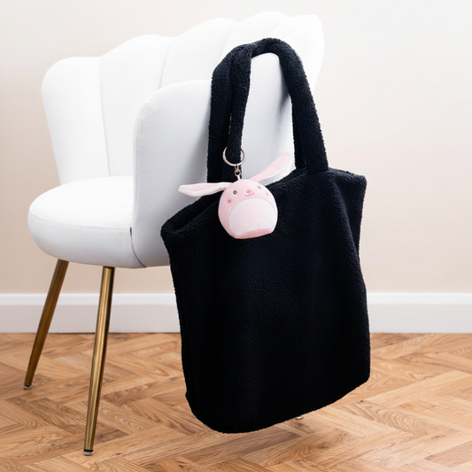 Mumbles Character Keyring bunny on black fleece shopper with white velvet chair
