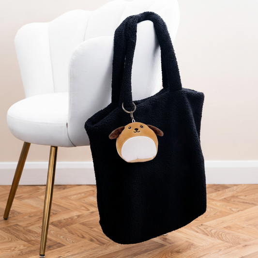 Mumbles Character Keyring dog on black fleece shopper with white velvet chair