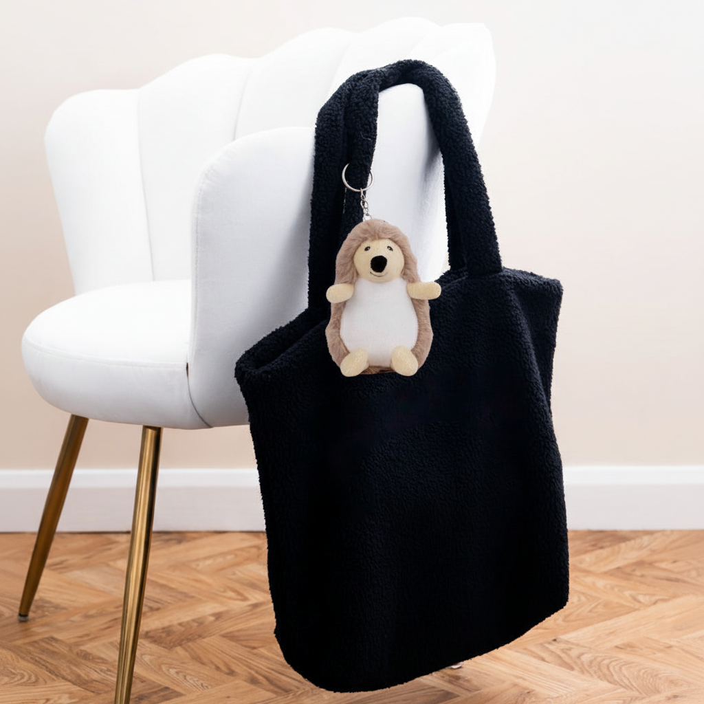 Mumbles Character Keyring hedgehog on black fleece shopper with white velvet chair