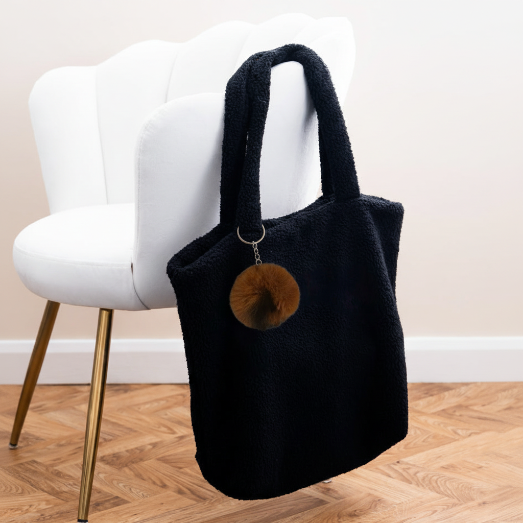 Pom Pom Keyring on black fleece shopper with white velvet chair